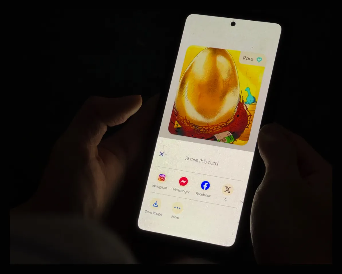 Someone holding a phone in the dark, sharing a Climasaur card.